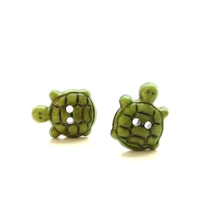 May include: Two green plastic turtle buttons with two holes each.