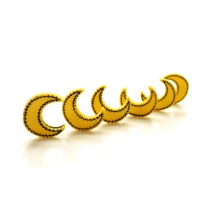 May include: A row of six yellow crescent moon shapes with black stitching, arranged in a line on a white background.