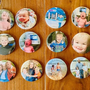 May include: Twelve round buttons with various photos printed on them. The photos include a baby, a child in a hospital bed, a child in a police uniform, a child in a blue shirt, a child in a red shirt, a child in a white shirt, a child in a blue shirt, a child in a white shirt, a child in a blue shirt, a child in a white shirt, a child in a blue shirt, and a family of five.