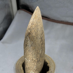 An ancient, handmade prehistoric hand axe from the Neolithic phase, discovered in Sanghao Cave, Pakistan.