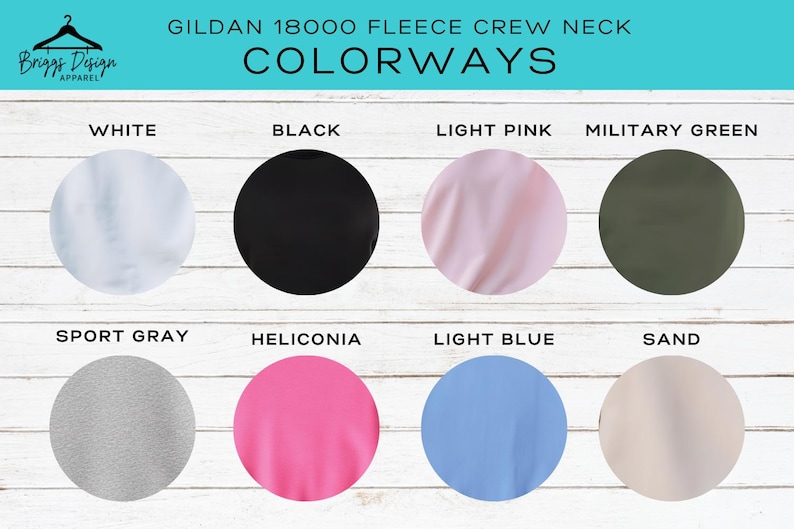 May include: Image showcasing the color options for a Gildan 18000 fleece crew neck sweatshirt. The colorways include white, black, light pink, military green, sport gray, heliconia, light blue, and sand. The brand name is Briggs Design Apparel.