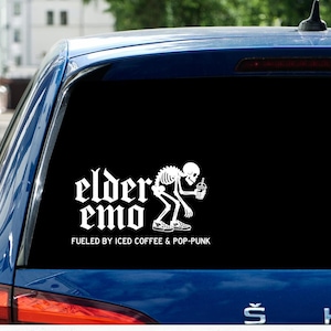 Pode incluir: Autocolante de carro em vinil branco com as palavras "elder emo" em fonte gótica, com um esqueleto segurando um café gelado. O texto "fueled by iced coffee & pop-punk" está abaixo. O autocolante está na janela azul de um carro.