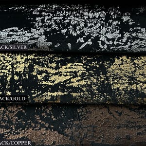 May include: Close-up of three fabric swatches with a black base and different metallic finishes: silver, gold, and copper. The swatches are labelled "BLACK/SILVER", "BLACK/GOLD", and "BLACK/COPPER".