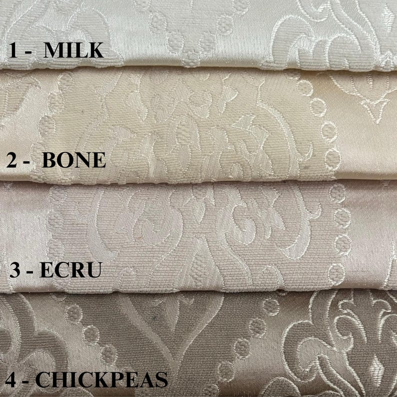 Puede incluir: Cuatro muestras de tela en diferentes tonos de blanco y beige. Las muestras est&aacute;n etiquetadas como 1- Leche, 2- Hueso, 3- Crudo y 4- Garbanzos.
