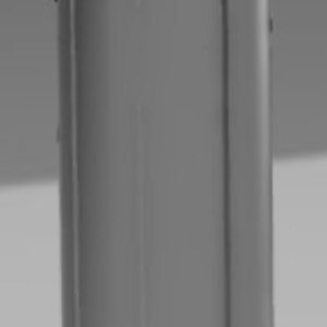 May include: A gray metal cylinder with a smooth, rounded top and bottom. The cylinder has three small holes on the bottom.