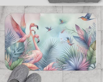 May include: A pink and blue bathroom rug with a tropical design featuring pink flamingos and blue birds. The rug has a watercolor effect and features green and purple palm leaves.