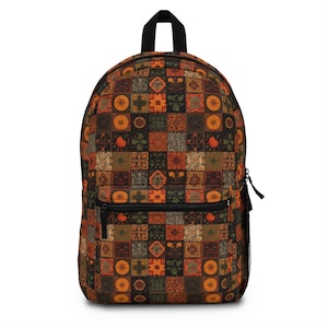 May include: A backpack with a colorful patchwork design. The pattern features squares in shades of brown, orange, and green, with various floral and geometric motifs. The backpack has a black top handle, a front pocket, and a side mesh pocket.