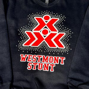 May include: Black sweatshirt with a red and white graphic design. The design features two overlapping red X shapes with a white outline and small white dots. The text "WESTMONT STUNT" is in red with a white outline.