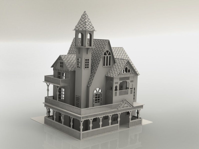 May include: A detailed, gray miniature house with a tower, balconies, and intricate architectural details. The house features multiple windows, a shingled roof, and a porch with decorative railings. The overall design suggests a Victorian or similar style.
