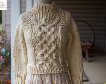 Könnte beinhalten: Cremefarbener, handgestrickter Pullover mit hohem, geripptem Rollkragen. Die Vorderseite hat ein zentrales Zopfmuster. Der Pullover hat lange Ärmel und einen gerippten Saum. Das Kleidungsstück wird auf einer Büste präsentiert.