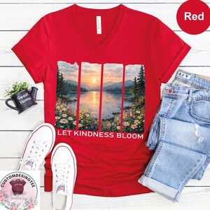 a red t-shirt with a scenic landscape design, a pair of jeans, a pair of white sneakers, and a small potted plant.
