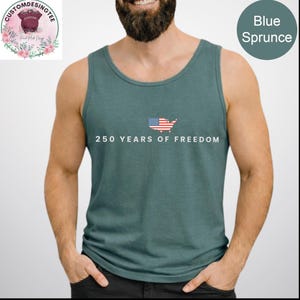 A man wearing a green tank top with the text "250 YEARS OF FREEDOM" printed on it.