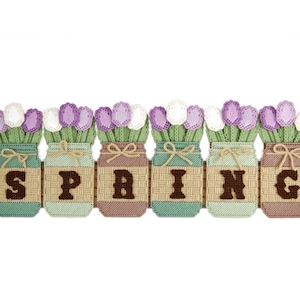 May include: A handmade craft project featuring six mason jars with purple and white flowers, spelling out the word "SPRING" in brown letters.