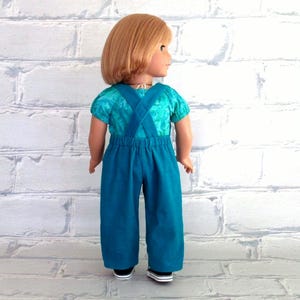 The overalls criss-cross in back, the back waistband has elastic inserted in it.