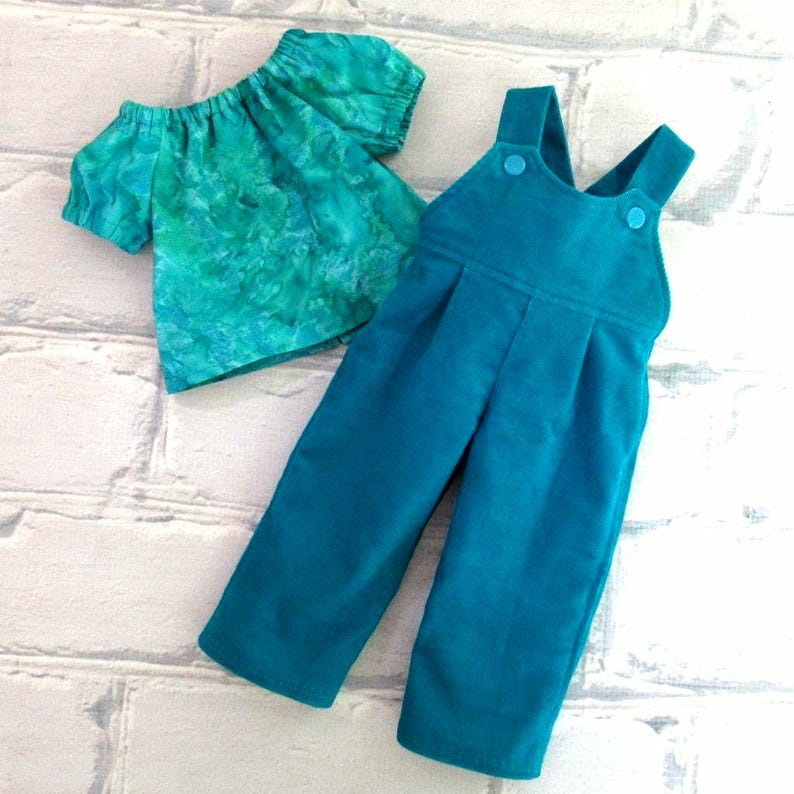 Shirt and overalls laid flat.