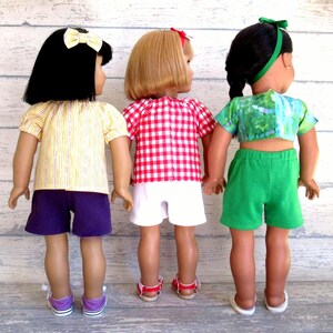 This photo shows the back of three of the summer outfits for 18 inch dolls.