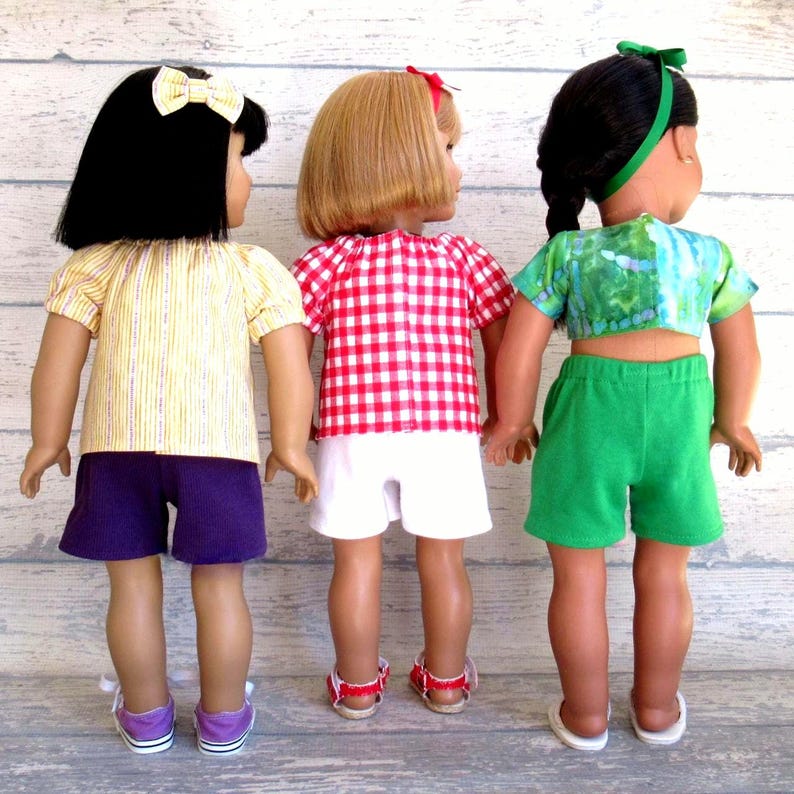 This photo shows the back of three of the summer outfits for 18 inch dolls.