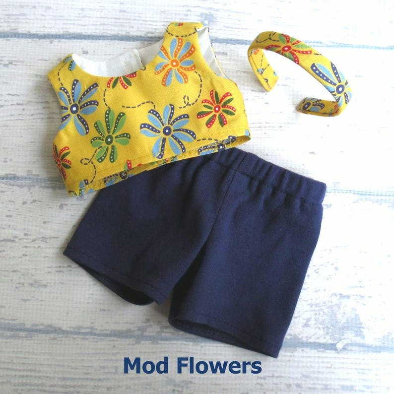 This summer set for your 18 inch doll includes a crop top in golden yellow mod flowers in blue, orange, red, and green.  It comes with a pair of blue stretch knit shorts and a headband covered with the shirt fabric.