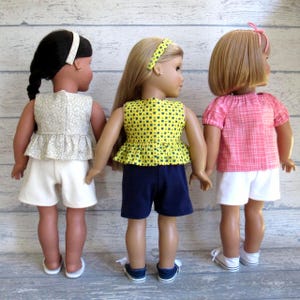 This photo shows the back of 3 of the summer outfits for 18 inch dolls.