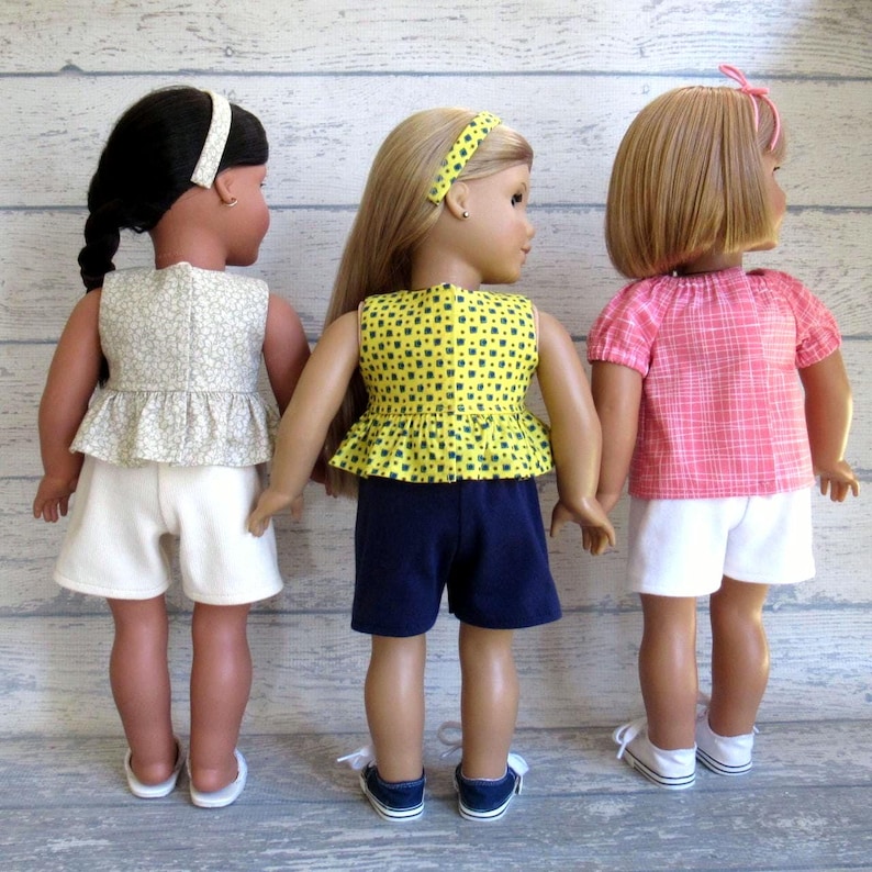 This photo shows the back of 3 of the summer outfits for 18 inch dolls.