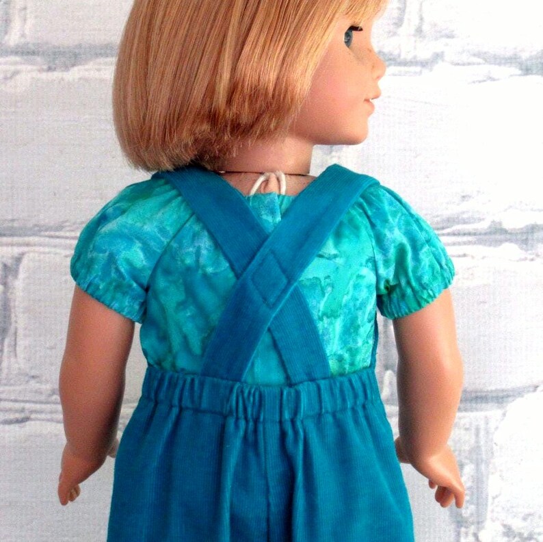Closeup view shows back elastic waistband and the criss-cross straps sewn together.