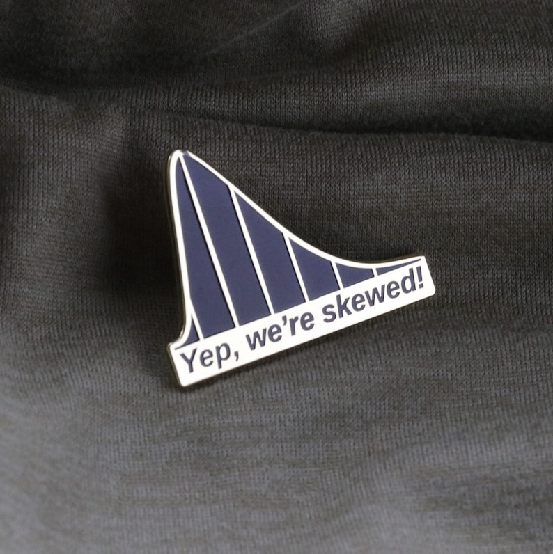 May include: A silver pin with a blue skewed bell curve graphic and the text "Yep, we're skewed!"