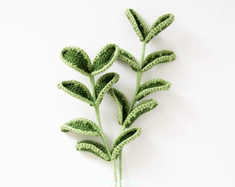 May include: Two green crocheted stems with multiple leaves. Each stem has five leaves that are crocheted in a heart shape.