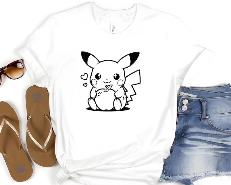 May include: A white t-shirt with a black and white cartoon image of Pikachu holding an apple.