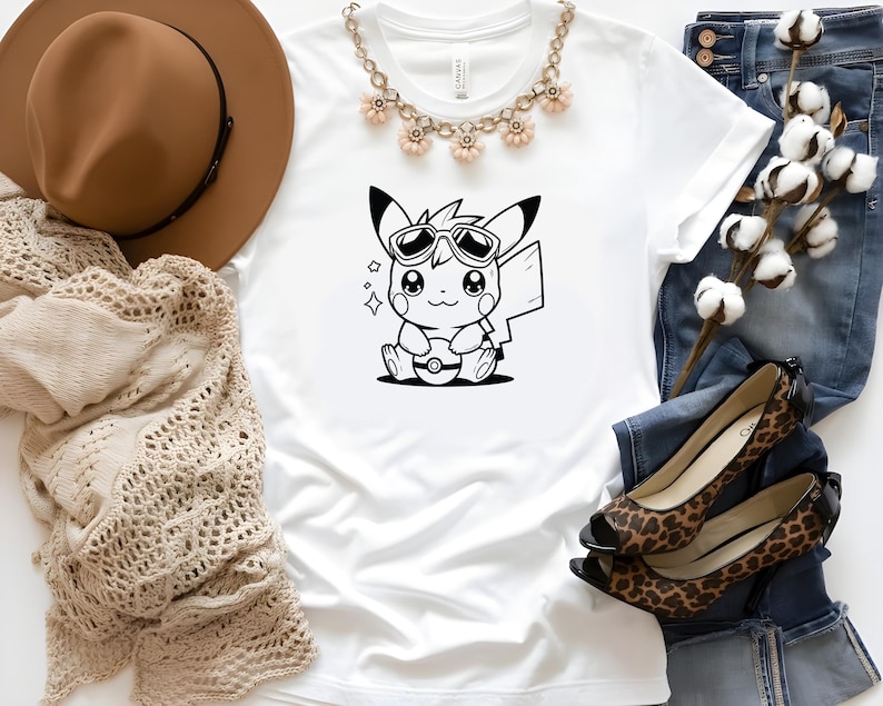 May include: A white t-shirt with a black and white cartoon image of a Pikachu wearing sunglasses and holding a Pokeball. The image is centered on the shirt.