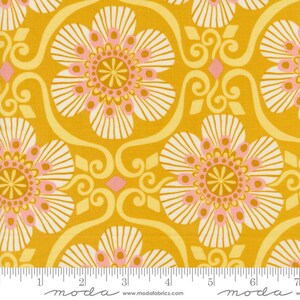 May include: Yellow fabric with a white and pink floral pattern. The fabric has a repeating pattern of stylized flowers with a central circle and a ring of petals. The fabric is perfect for quilting, sewing, and crafting.