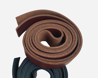 May include: Two rolls of leather straps, one brown and one dark blue. The brown leather strap is rolled up and the dark blue leather strap is rolled up and placed on top of the brown leather strap.