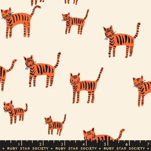 May include: Off-white fabric patterned with orange tigers and black stripes. The tigers are depicted in different poses. The fabric has a playful design, suitable for children's items or home decor. The fabric has a repeating pattern of tigers.