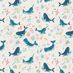 May include: A repeating pattern featuring illustrations of whales and narwhals in shades of blue. The design includes colorful coral, seaweed, and bubbles on a cream background. The whales and narwhals are swimming in the ocean.