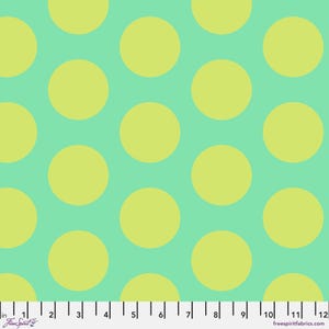 May include: A fabric pattern featuring large, evenly spaced yellow circles on a light teal background. The image includes a ruler along the bottom edge, with the text "Free Spirit" and "freespiritfabrics.com".
