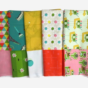May include: Five fabric swatches with different patterns. The first swatch has a geometric pattern of red, yellow, and green triangles. The second swatch has a teal background with a pattern of Parisian landmarks. The third swatch has a yellow background with a pattern of a city map. The fourth swatch has a green background with a pattern of white daisies and green buttons. The fifth swatch has a green background with a pattern of yellow signs with the word "JOB" on them.