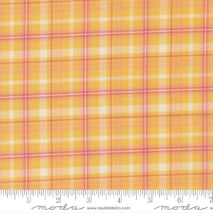 May include: Yellow and pink plaid fabric with a grid pattern. The fabric has a repeating pattern of yellow, pink, and white lines. The fabric is marked with a ruler and the word "moda".