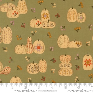 May include: A sage green fabric featuring a repeating pattern of cream-coloured pumpkins and gourds decorated with floral, geometric, and star motifs, interspersed with small orange and purple flowers, with a ruler showing 18 cm at the bottom.