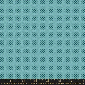 May include: A teal blue fabric with a repeating pattern of small, dark blue polka dots.