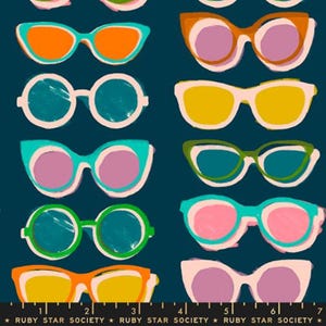 May include: A dark teal fabric featuring a repeating pattern of various sunglasses in colors including orange, pink, yellow, green, and light blue. A black ruler at the bottom shows measurements in inches, labeled with the text Ruby Star Society.