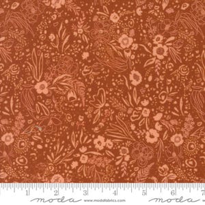 May include: Close-up of a fabric with a floral pattern. The fabric has a warm, reddish-brown background with a delicate design of peach-colored flowers and leaves. The design is detailed and intricate, with various sizes of flowers and foliage.