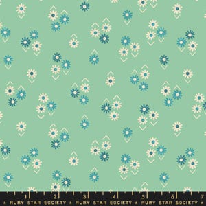 May include: A mint green fabric with a repeating pattern of white and blue flowers. The flowers are arranged in groups of three and are surrounded by a white chevron pattern.