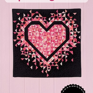 May include: A pink and white exploding heart quilt pattern with a black background. The quilt is made up of small triangles and is in the shape of a heart. The quilt is surrounded by a black border. The text "MINI Exploding Heart" is at the top of the image. The text "Slice of Pi Quilts" is in a circle at the bottom of the image.