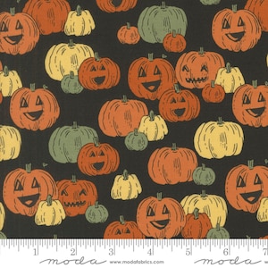 May include: Fabric with a Halloween design. It features a repeating pattern of orange, yellow, and green pumpkins with carved faces on a black background. The pumpkins vary in size. The fabric has a ruler along the bottom with the word "moda" and website address.