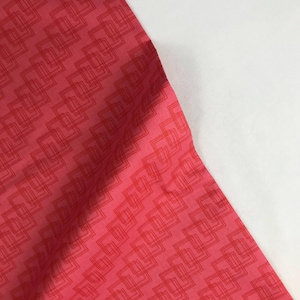 May include: Red fabric with a geometric pattern of overlapping squares in a lighter shade of red.