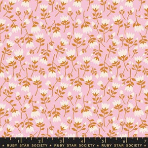 May include: A pink fabric with a repeating pattern of white flowers with gold stems and leaves. The fabric has a subtle texture.