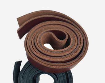May include: Two rolls of leather straps, one brown and one dark blue. The brown leather strap is rolled up and the dark blue leather strap is rolled up and placed on top of the brown leather strap.