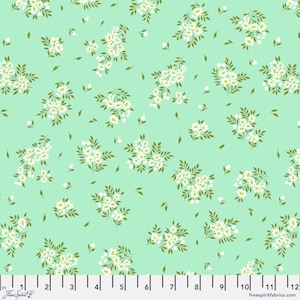 May include: A mint green fabric with a white floral pattern. The fabric is covered in small white flowers with green leaves.