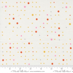 May include: White fabric featuring a pattern of randomly scattered dots in orange, yellow, pink, and grey. The dots vary in size and are evenly spaced. A ruler is at the bottom of the fabric, with the word "moda" printed on it.