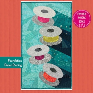 May include: A quilt pattern titled "Bonnie the Bobbin" with dimensions of 16" x 29". The design features stacked, stylized bobbins in shades of gray, pink, yellow, and orange against a teal and turquoise background. The text "Foundation Paper Piecing" is also visible.