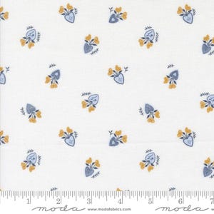 May include: White fabric with a repeating pattern of yellow flowers and blue heart-shaped vases. The fabric has a ruler along the bottom edge with the word "moda" printed on it.